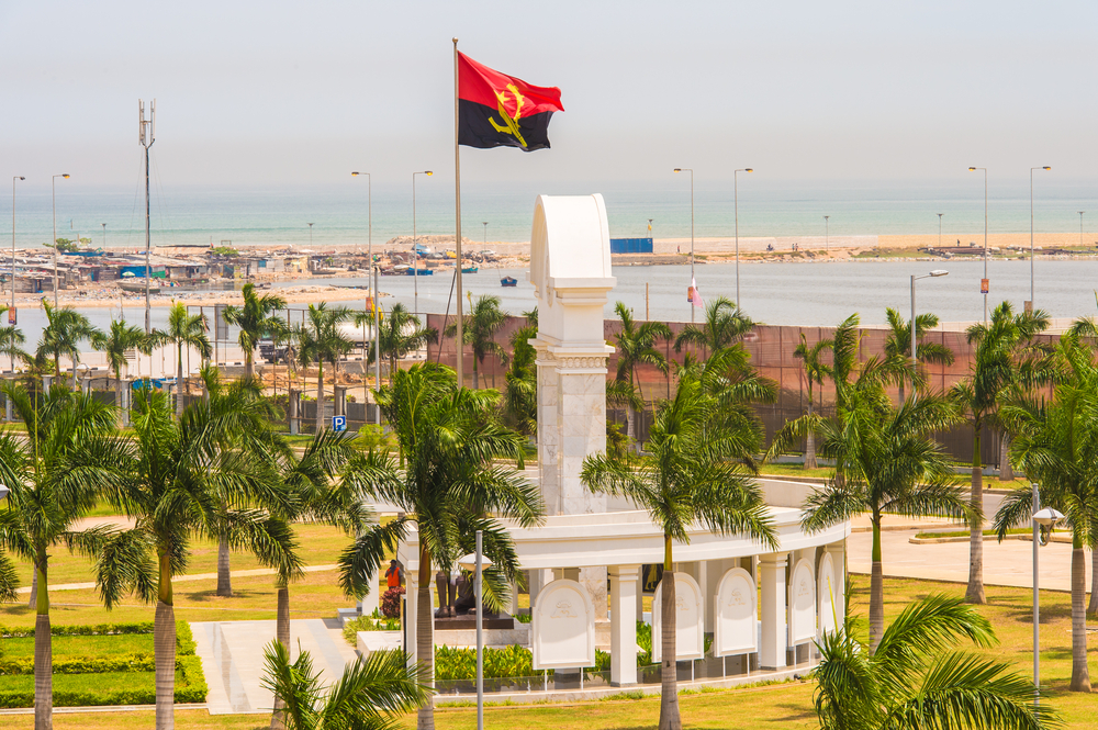 Angolanische Flagge vor Denkmal in Luanda